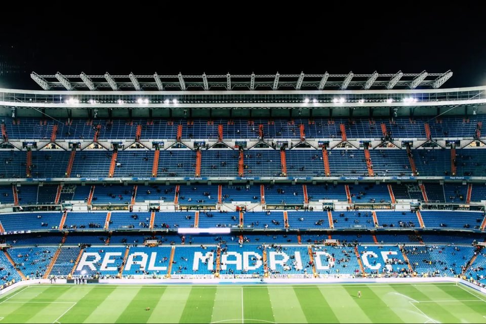 Grada del estadio Santiago Bernabéu de noche, con las letras Real Madrid CF en los asientos